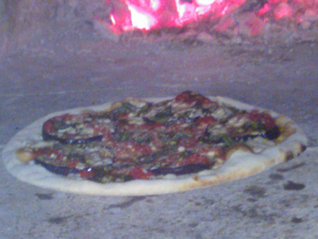 pizza parmigiana in cottura_forno a legna
